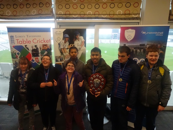 disability cricketers receiving trophy